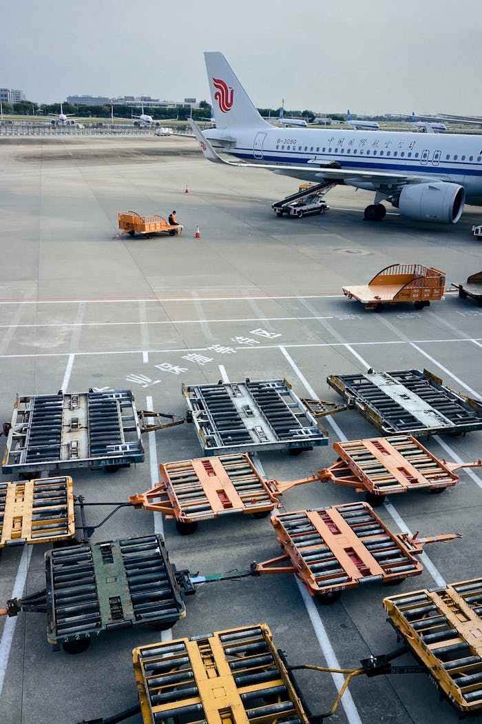 Ground crew and equipment around plane at Guangzhou Airport